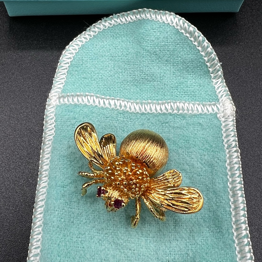 Tiffany & Co. 18K Gold Bee Brooch Pin with Ruby Eyes. Measures 1” by 1.5”